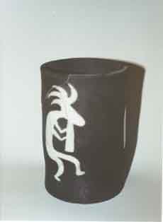 Raku cylinder with transparent glaze with kokopelli motif