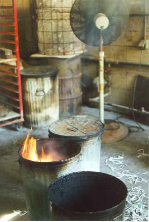 A fan is used to help eliminate the smoke resulting from the pottery being placed in the reduction chambers